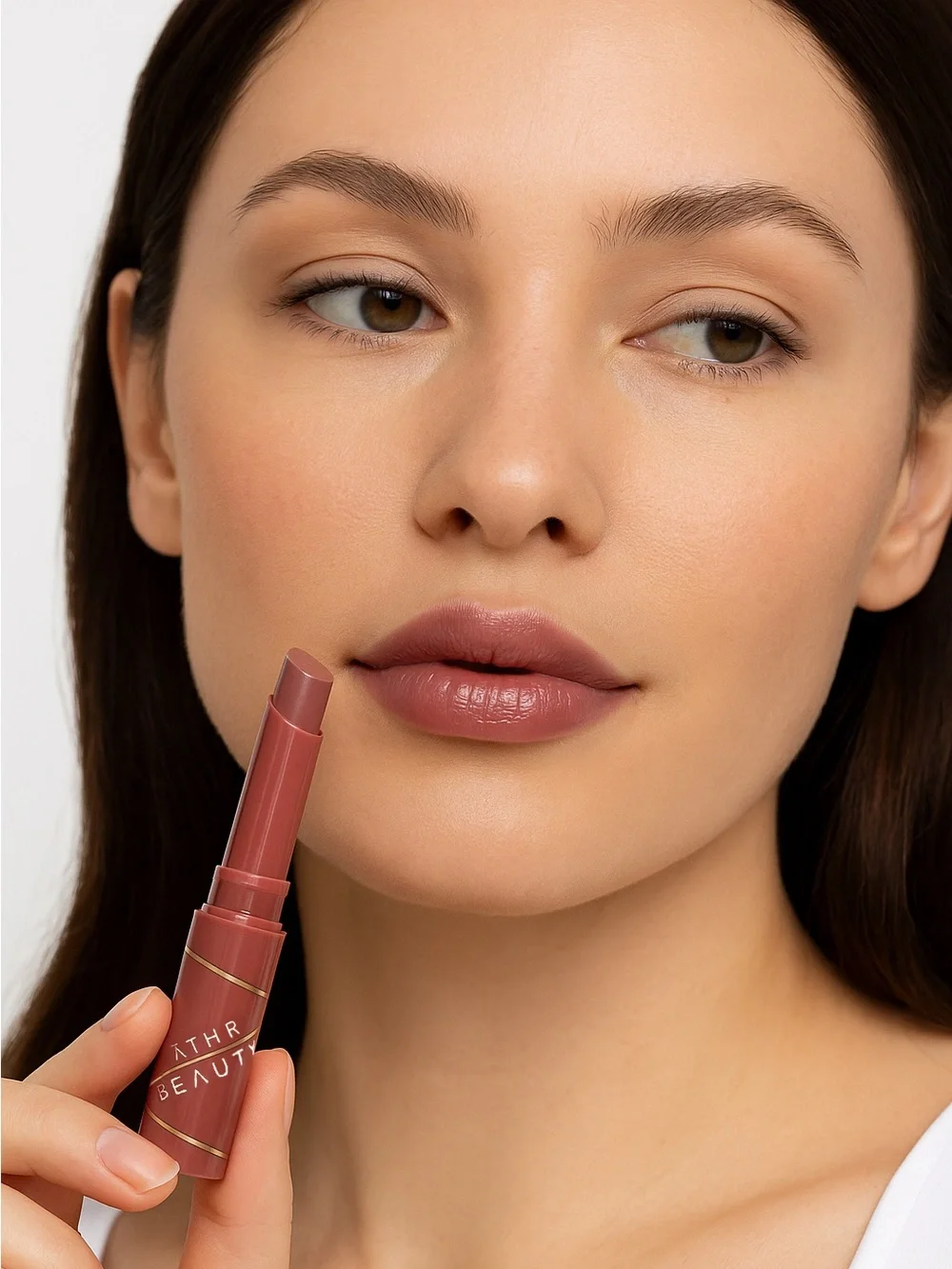 ATHR Beauty Dewy Quench Tinted Gloss Stick - in Aura (Mauve- Brown)